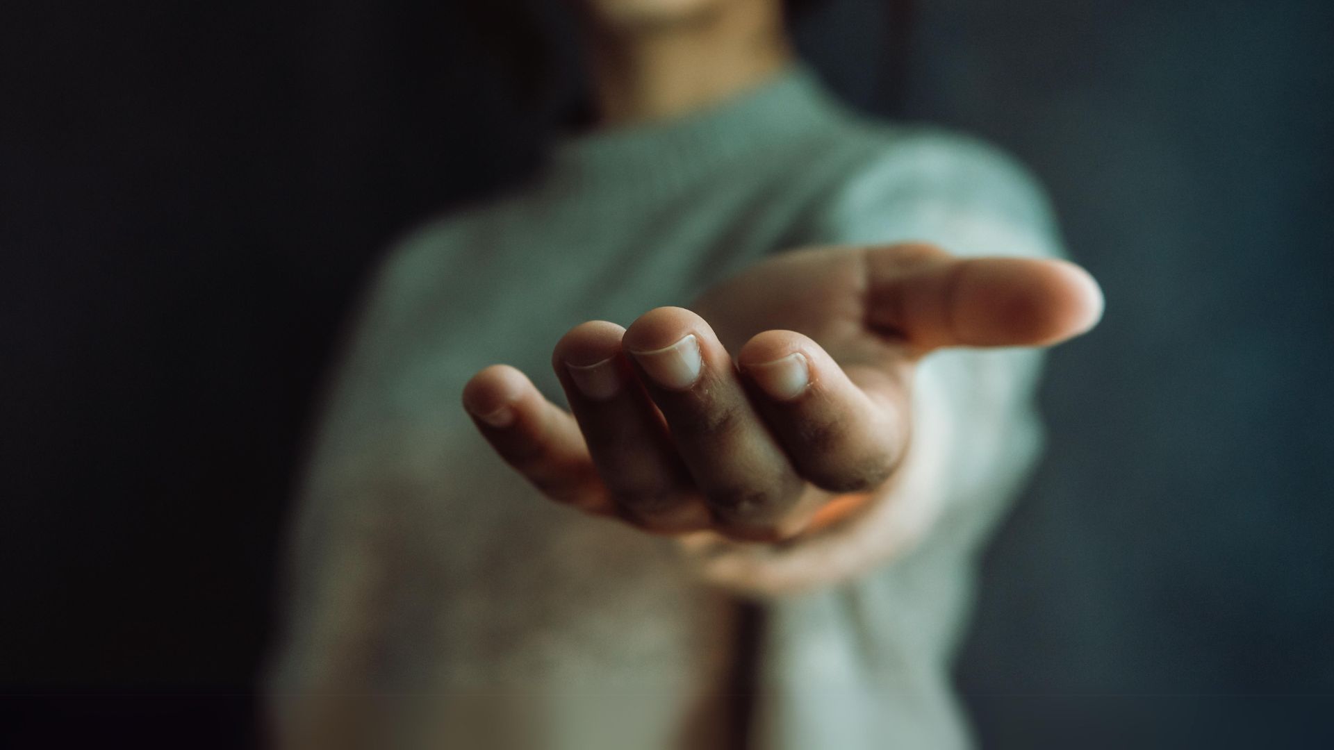 woman giving hand to the camera, help and self help concept