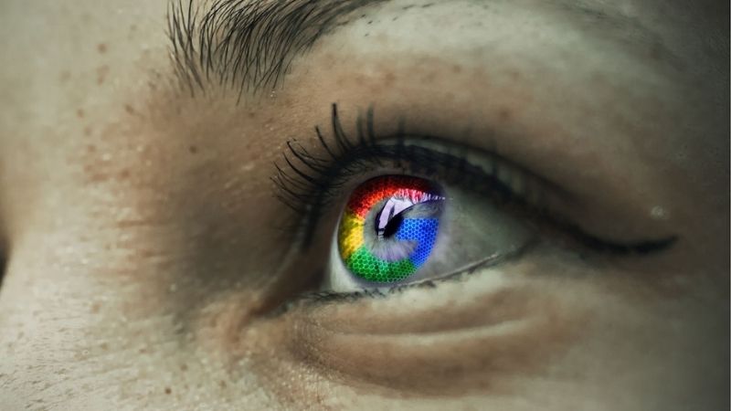 Close-up of a human eye reflecting a colourful Google logo