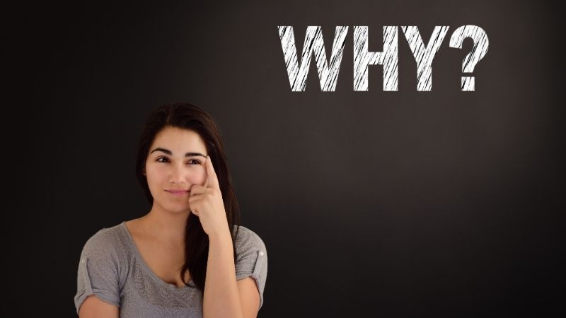 Woman pointing to her temple with the word “WHY?” written above her