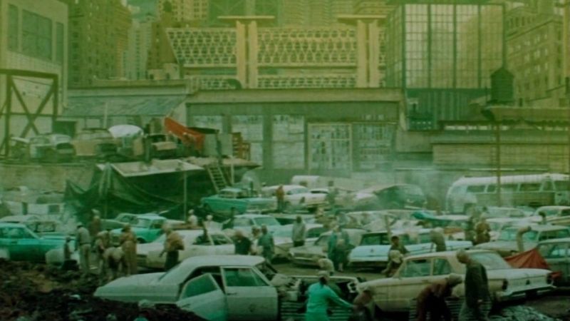 Crowded urban scene with parked cars and people in a dystopian setting