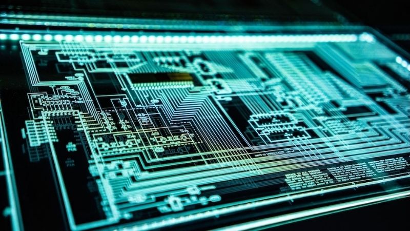 Detailed circuit board with electronic lines and glowing neon lights, the heart of technology