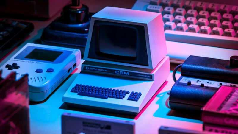 Vintage Commodore CBM model 8032 surrounded by retro gaming gadgets