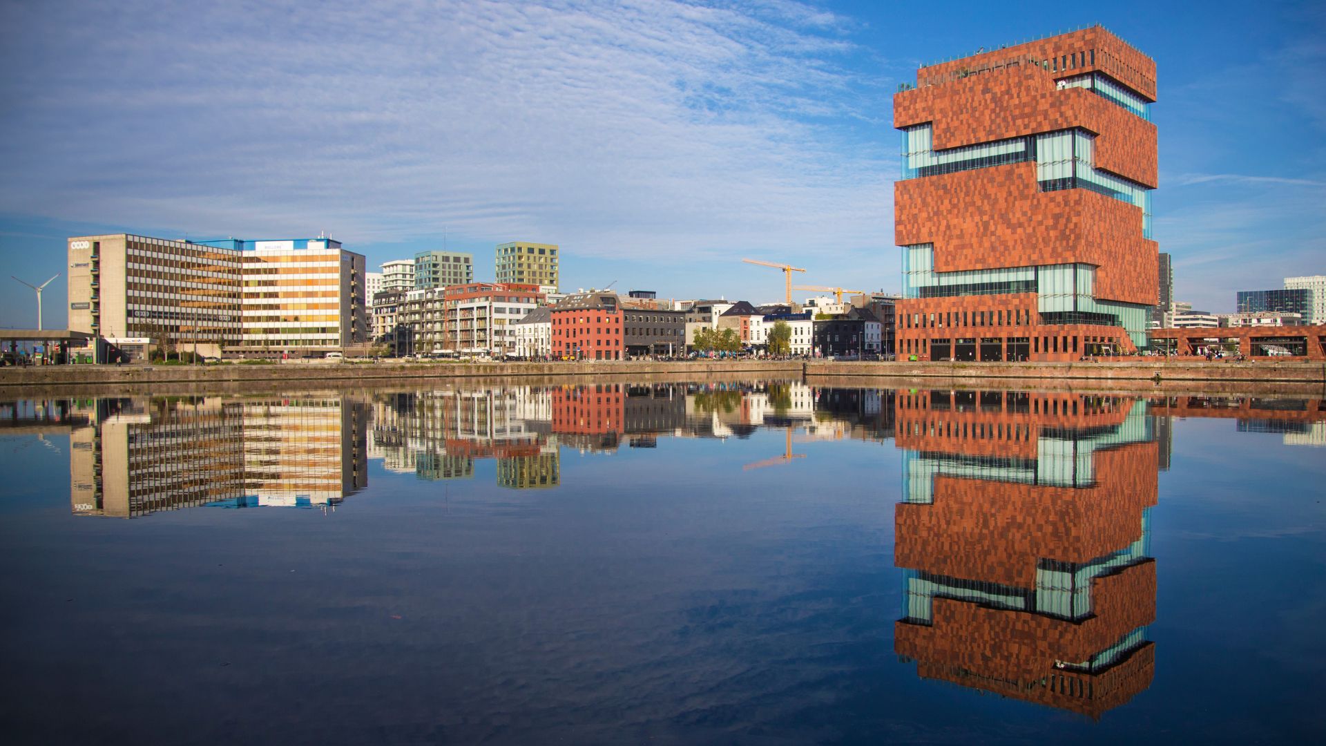 The Museum aan de Stroom (MAS), a modern museum in Antwerp, Belgium, reflected in a canal