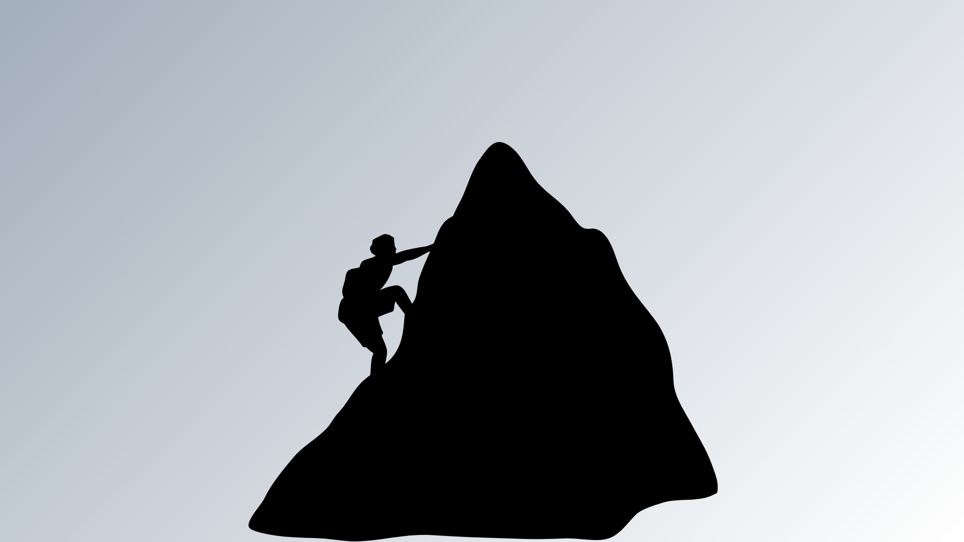 Silhouette of a person climbing a mountain